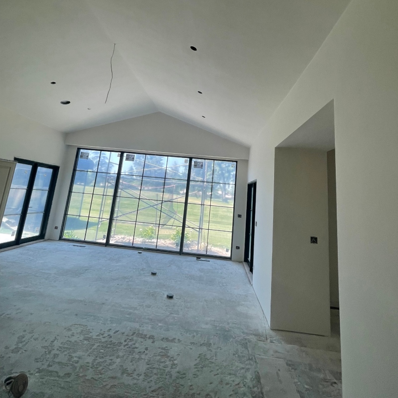 Multiple images showcasing a drywall installation project, from framing to finished walls and ceilings