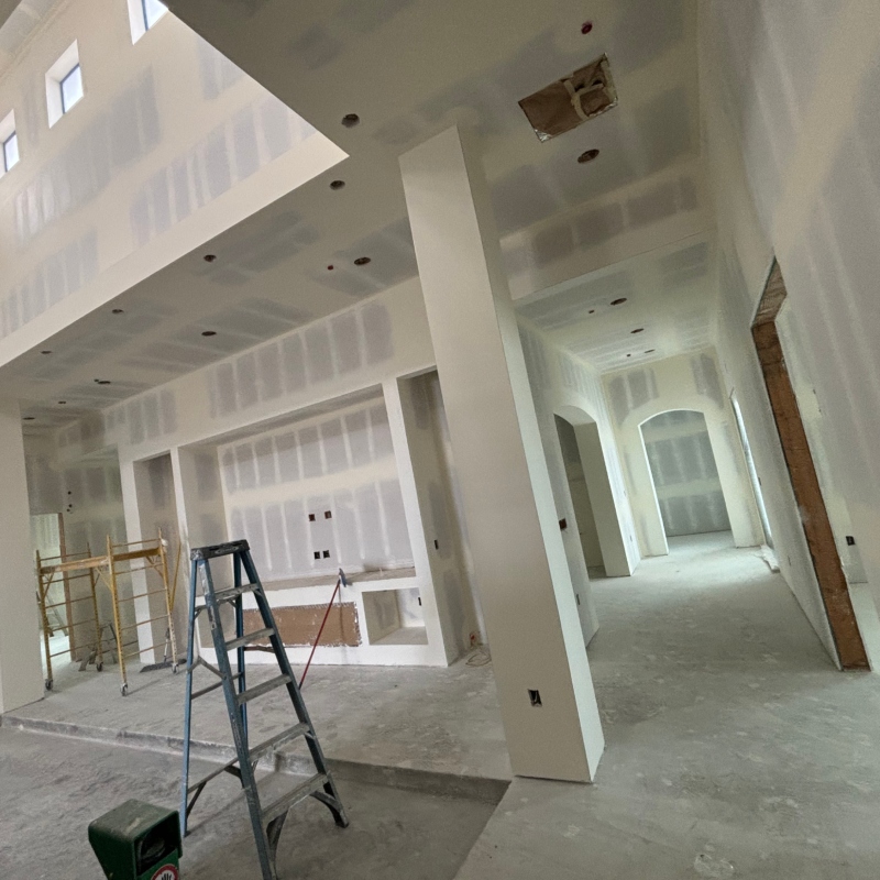 Drywall installation highlighting the process of transforming a space with smooth, finished surfaces